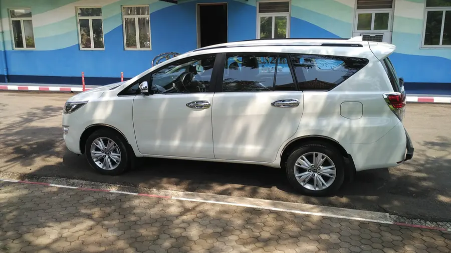 White Toyota Innova Crysta side profile, 7-seat premium MUV